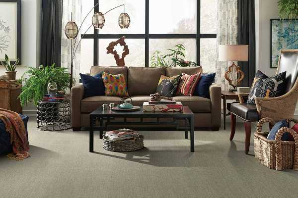 Eclectic living room with  neutral carpet and bold pillows